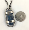 This custom pendant is a raw dark blue Aquamarine stone from Mozambique free floating in a handmade sterling silver cage with a heavy duty sterling silver chain and clasp by Dax Savage Jewelry.