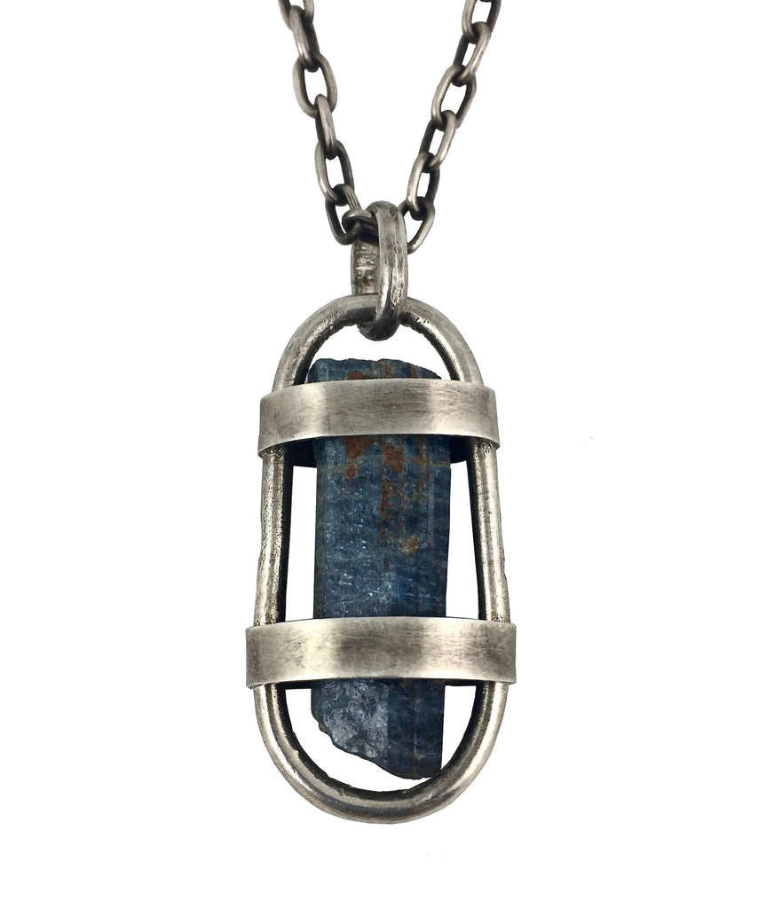 Dax Savage Jewelry This custom pendant is a raw dark blue Aquamarine stone from Mozambique free floating in a handmade sterling silver cage with a heavy duty sterling silver chain and clasp by Dax Savage Jewelry.